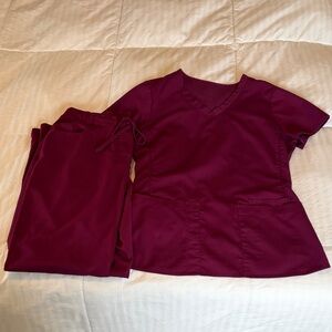 Scrubology scrub set in magenta, size small. Used in good condition.